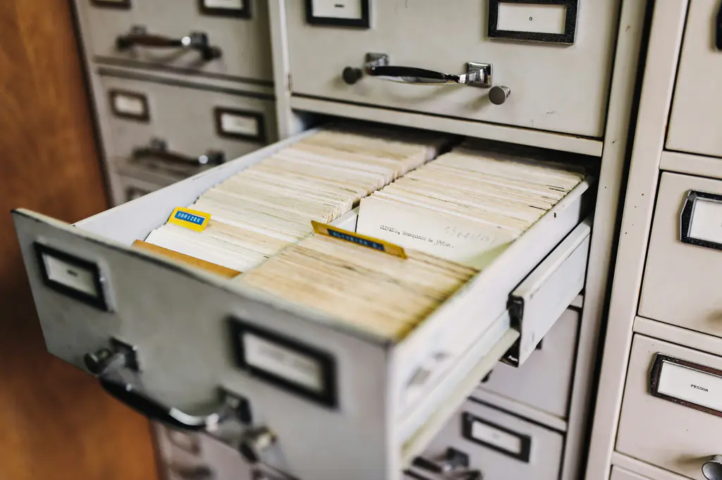 An open filing drawer packed with indexed record cards
