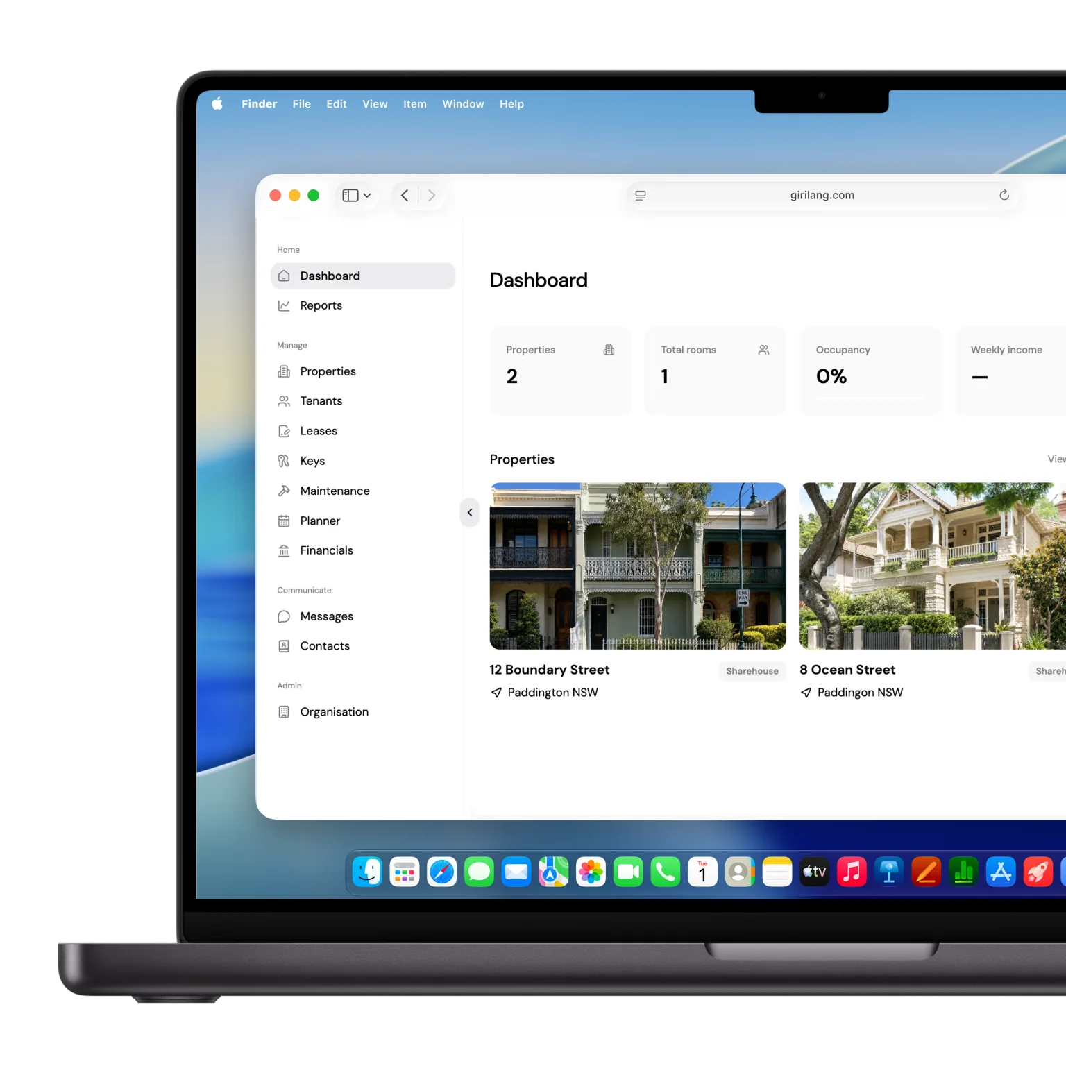 The Girilang dashboard displayed on a MacBook, with portfolio totals and property cards visible